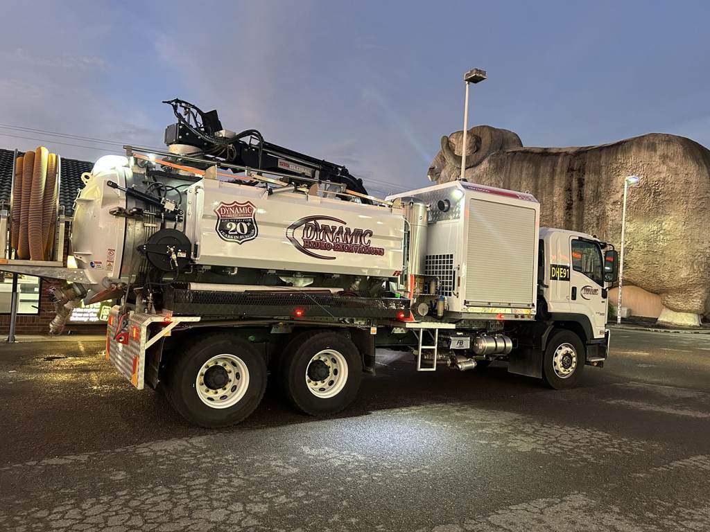 Signwritten Dynamic Hydro Excavations vacuum truck parked on site